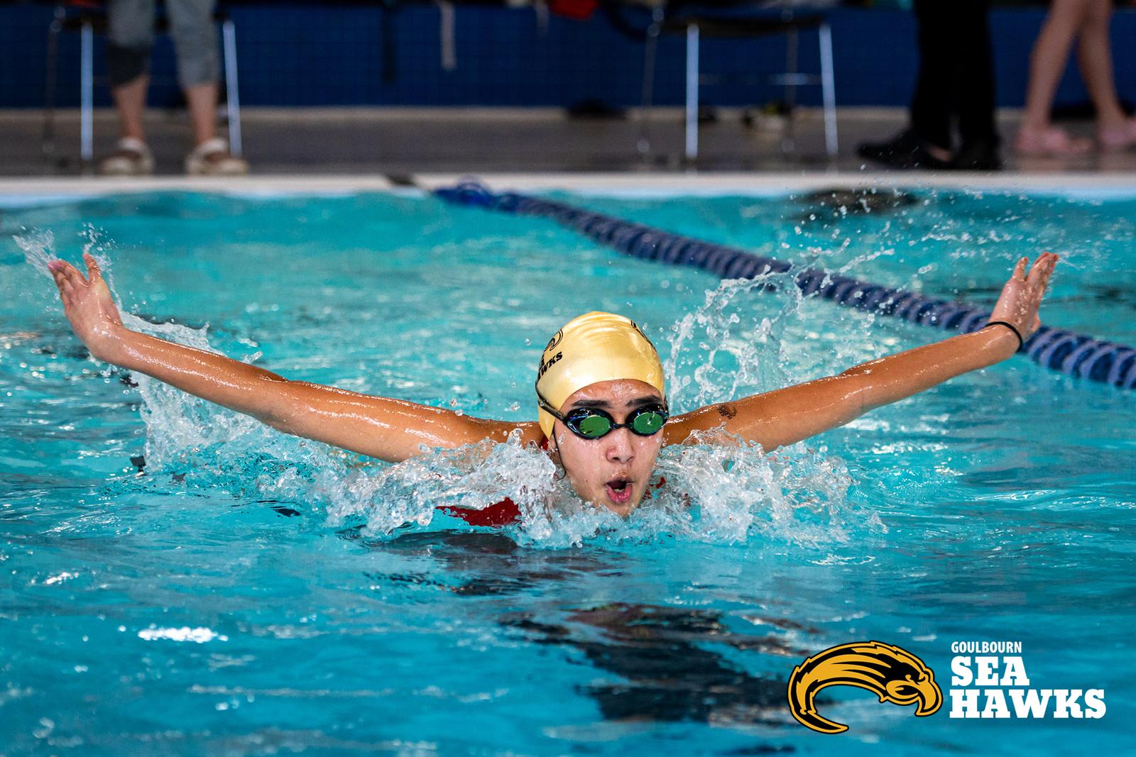 Aanya competing in butterfly stroke at a swim meet